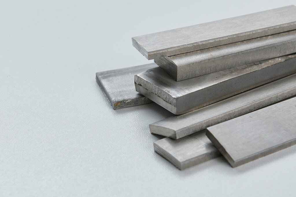 A pile of both hot and cold rolled steel flat bars.